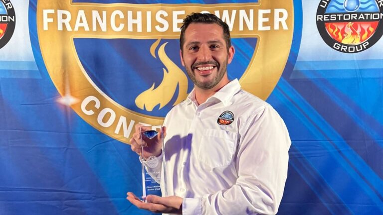 phil depaul holds an award