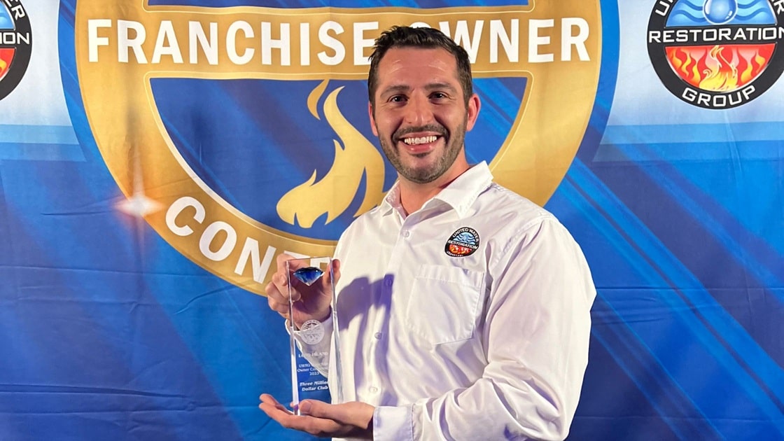 phil depaul holds an award